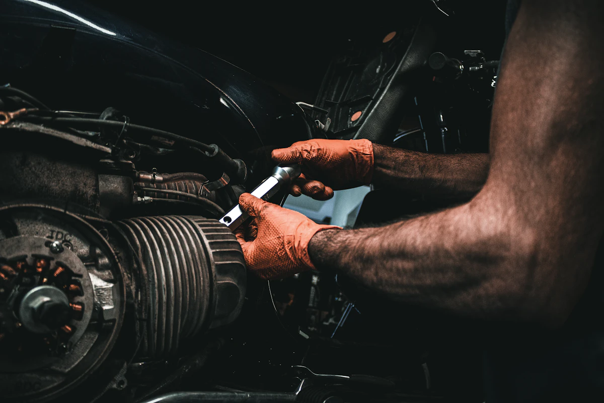 Mechanic working on a car engine with a wrench