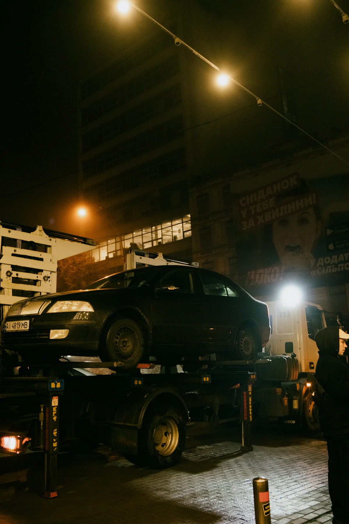 Car being towed on a flatbed tow truck